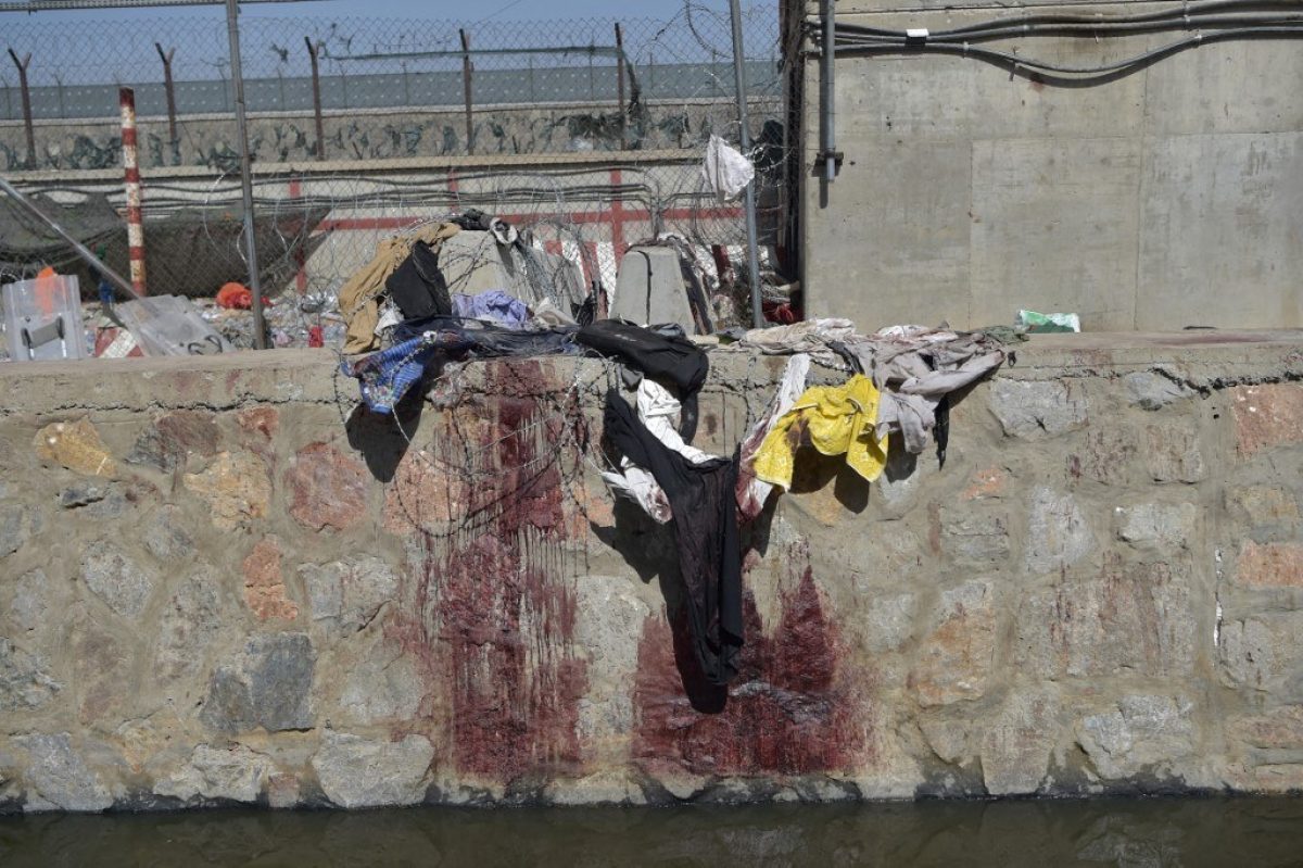 La ropa y las manchas de sangre de los afganos que esperaban ser evacuados se ven en el lugar de los dos atentados suicidas con bomba el 26 de agosto.